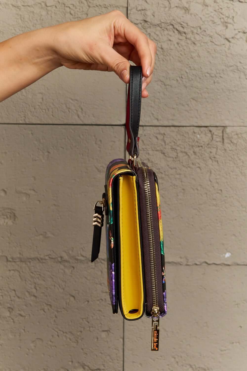 Nicole Lee USA small crossbody wallet showing side view with compartments and a removable strap.