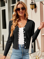 Woman wearing Bella Road Button Up Long Sleeve Cardigan with sunglasses and carrying a white purse.