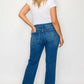 Woman in high-rise straight jeans, showcasing a flattering fit and vintage-inspired style from behind.