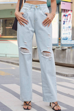 Woman wearing Baeful Distressed Straight Leg Jeans with Pockets, showcasing ripped details and street-style chic against an urban backdrop.