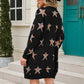 Woman wearing Angel Wings Star cardigan with playful star design, standing outdoors, showcasing stylish long sleeves and cozy fit.