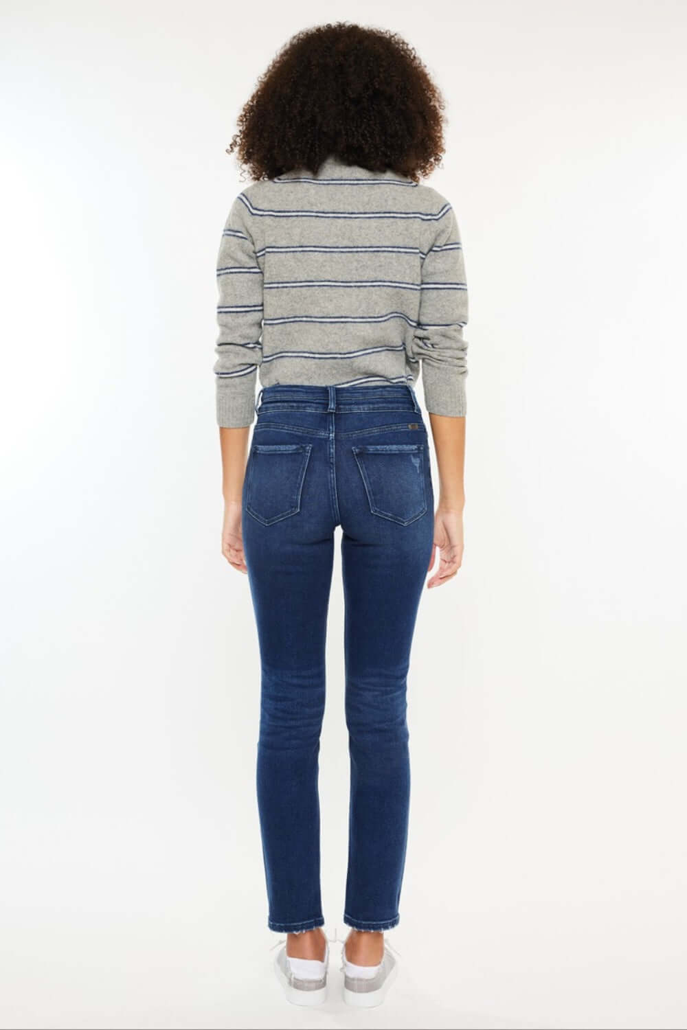 Woman wearing High Rise Slim Straight Jeans, highlighting the flattering fit and sleek silhouette from the back.