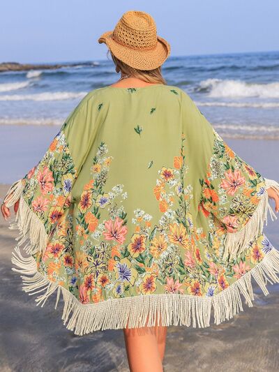 Plus size floral fringe cover-up in green, perfect beach outfit, featuring vibrant flowers and flowy sleeves.