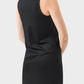 Woman wearing a sleeveless black Millennia dress, showcasing a round neck design perfect for active wear.