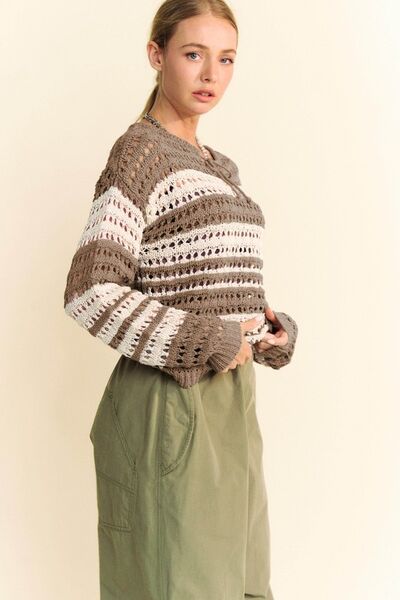 Stylish woman in Davi & Dani crochet drop shoulder cover up with contrasting stripes, paired with relaxed green pants.