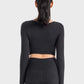 Back view of the Millennia Ruched Cropped Long Sleeve Sports Top in black, showcasing its stylish crop design and fitted look.