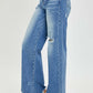 High Rise Frayed Hem Wide Leg Risen Jeans in light denim, featuring a flattering high-rise fit, wide legs, and edgy frayed hems.