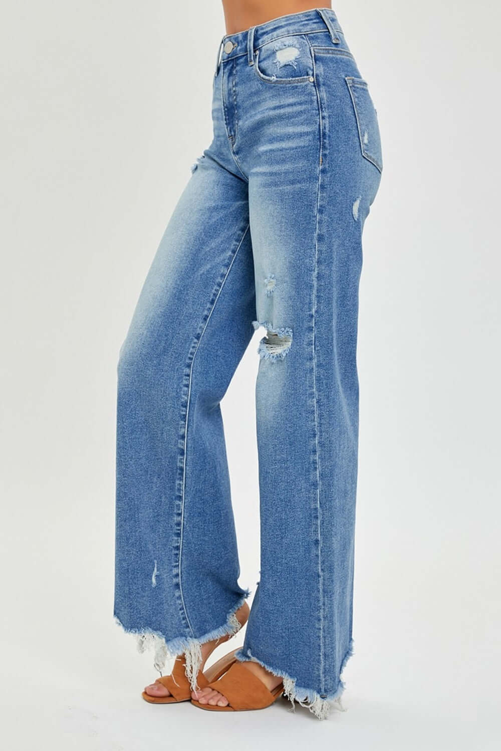 High Rise Frayed Hem Wide Leg Risen Jeans in light denim, featuring a flattering high-rise fit, wide legs, and edgy frayed hems.