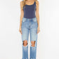 High Waist Chewed Up Straight Mom Jeans with distressed holes and frayed edges on woman, trendy vintage-inspired style for a flattering fit