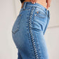 Woman wearing Judy Blue braid side detail wide leg jeans, showcasing stylish braid detailing along the side and classic five-pocket design.