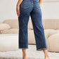 Woman wearing RFM Tummy Control High Waist Raw Hem Jeans, showcasing the back view and raw hem detailing