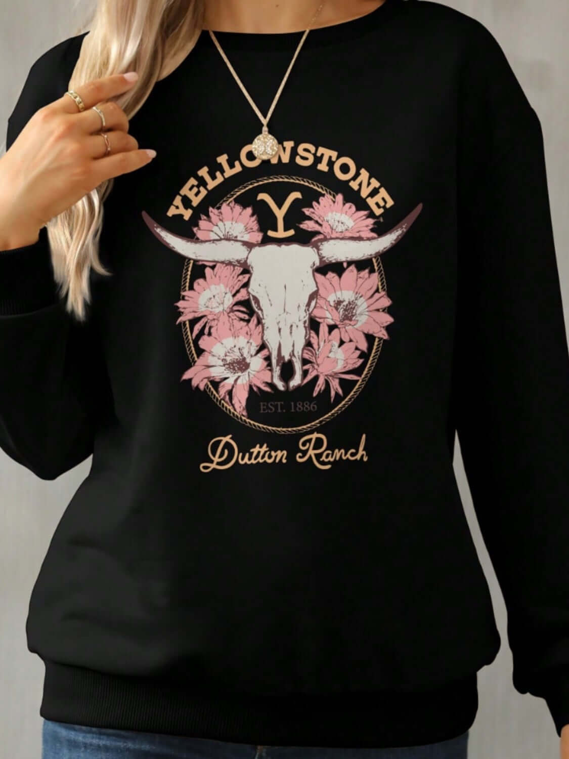 Bella Road Yellowstone Round Neck Long Sleeve Sweatshirt with floral and skull design, perfect for cozy cool weather style.