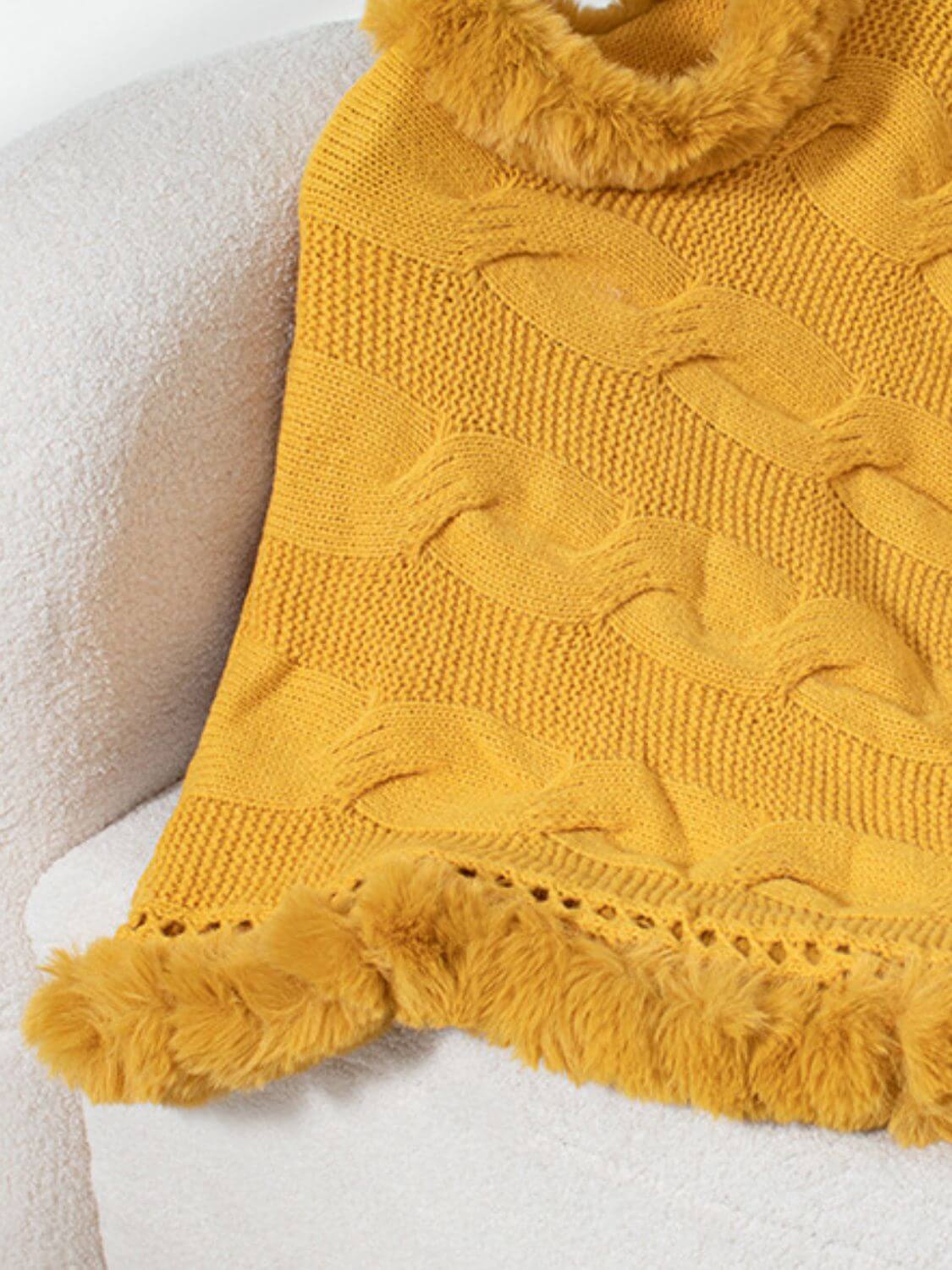 Cozy Bella Road Fuzzy Hem Cable-Knit Poncho in vibrant gold, featuring soft texture and stylish cable-knit design.