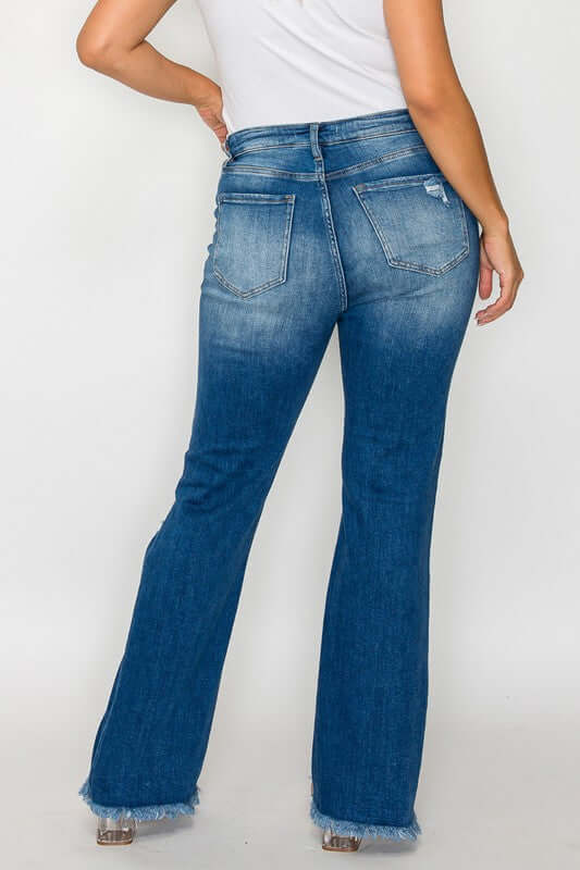 Back view of bytos Full Size Raw Hem Distressed Bootcut Jeans showcasing the unique raw hem and flattering fit.