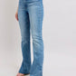 Judy Blue high waist slim bootcut jeans in vintage wash with tummy control and side slits, styled with a trendy top.