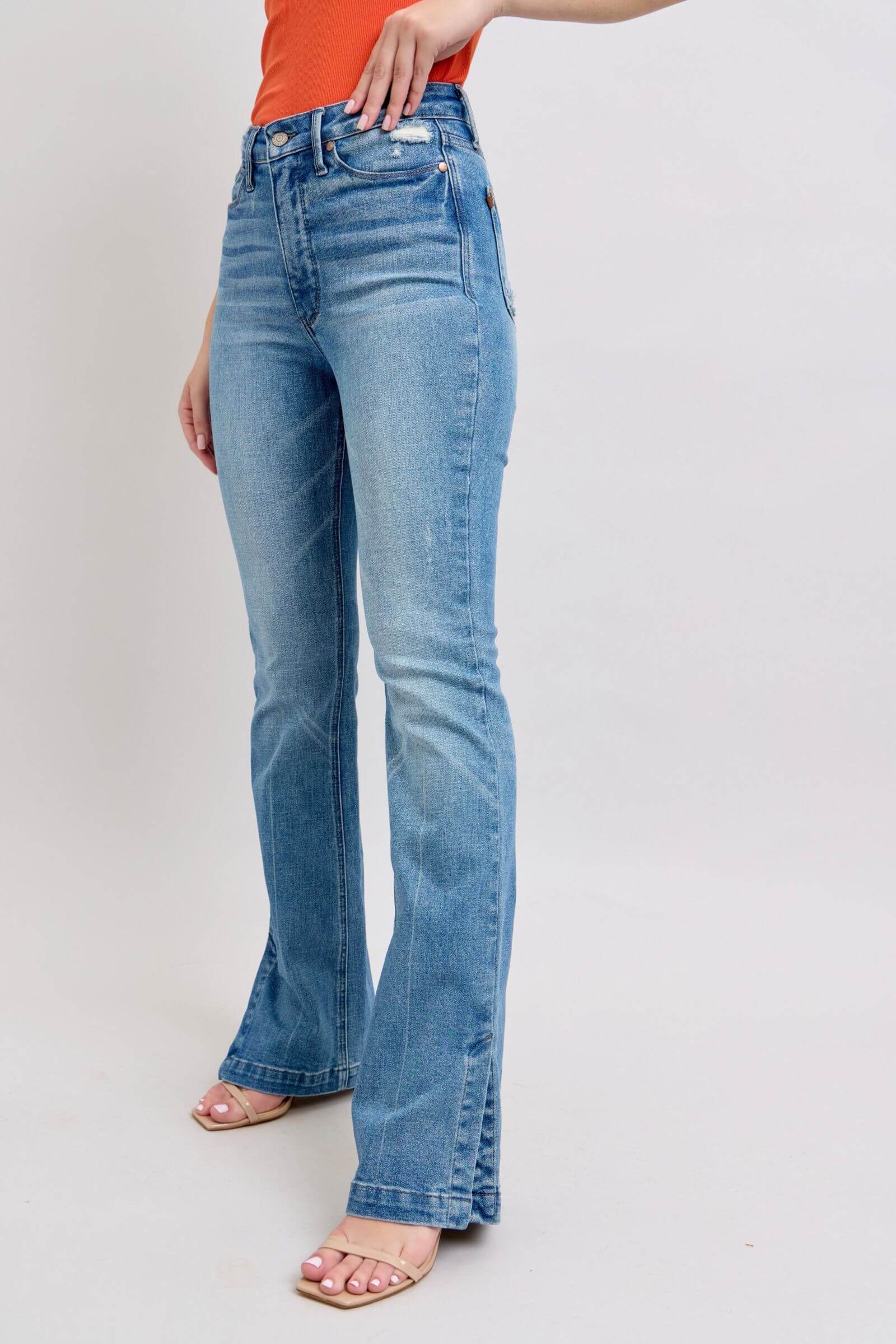 Judy Blue high waist slim bootcut jeans in vintage wash with tummy control and side slits, styled with a trendy top.