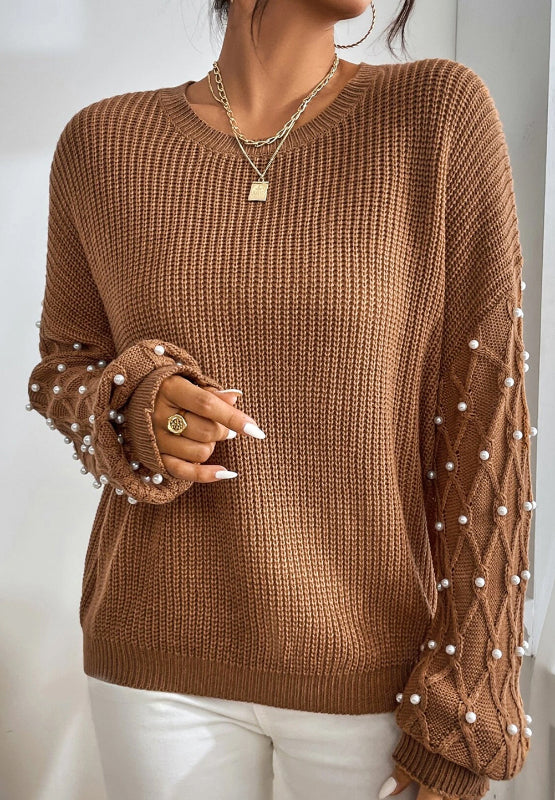 Woman wearing Bella Road Pearl Detail Round Neck Long Sleeve Sweater in brown with elegant pearl accents. Perfect for stylish occasions.