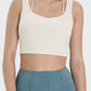 Stylish Millennia Crisscross Square Neck Active Tank in light beige, perfect for workouts and casual wear.