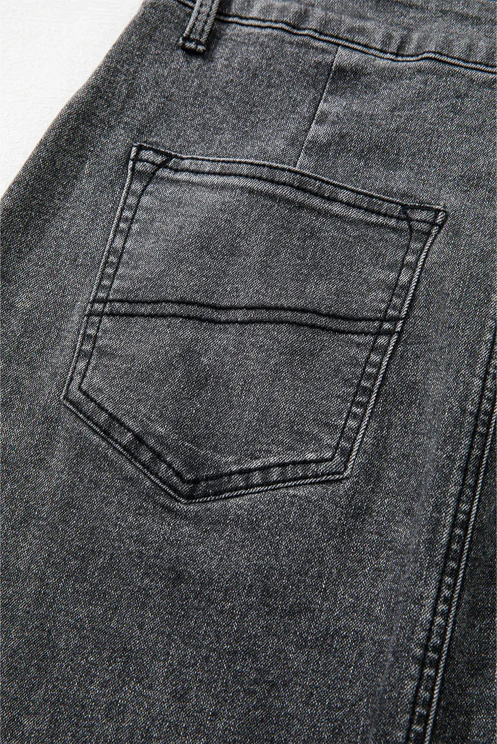 Close-up of Bella Road denim skirt pocket showcasing raw hem and high-quality fabric. Perfect for adding edgy style to any outfit.