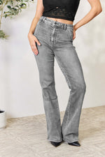 Woman modeling grey high waist slim flare jeans for a stylish and flattering look