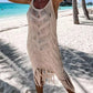 Chic khaki fringe cover-up at the beach, showcasing bohemian style by the turquoise water, perfect for poolside lounging.