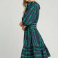 Woman in a stylish ribbon print frill dress with velvet trim, perfect for chic events and special occasions.