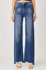 Stylish high rise frayed hem wide leg jeans by Risen Jeans offer a flattering fit and retro flair with a trendy edgy look.