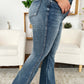 Woman wearing High Waist Tummy Control Flare Jeans by Judy Blue, side view showing the flattering fit and stylish flare leg design