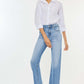 Woman wearing high waist raw hem straight jeans paired with white shirt and sandals, showcasing flattering fit and timeless style.