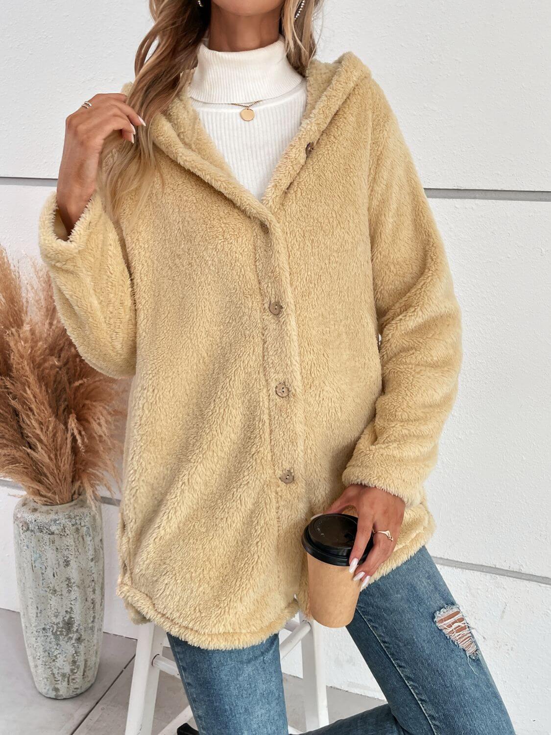 Cozy pastel yellow fuzzy button-up hooded jacket styled with ripped jeans and coffee, perfect for chilly days.