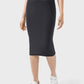 Model showcasing a sleek black Millennia Slit Wrap Active Skirt, perfect for active and casual wear with stretchy comfort.