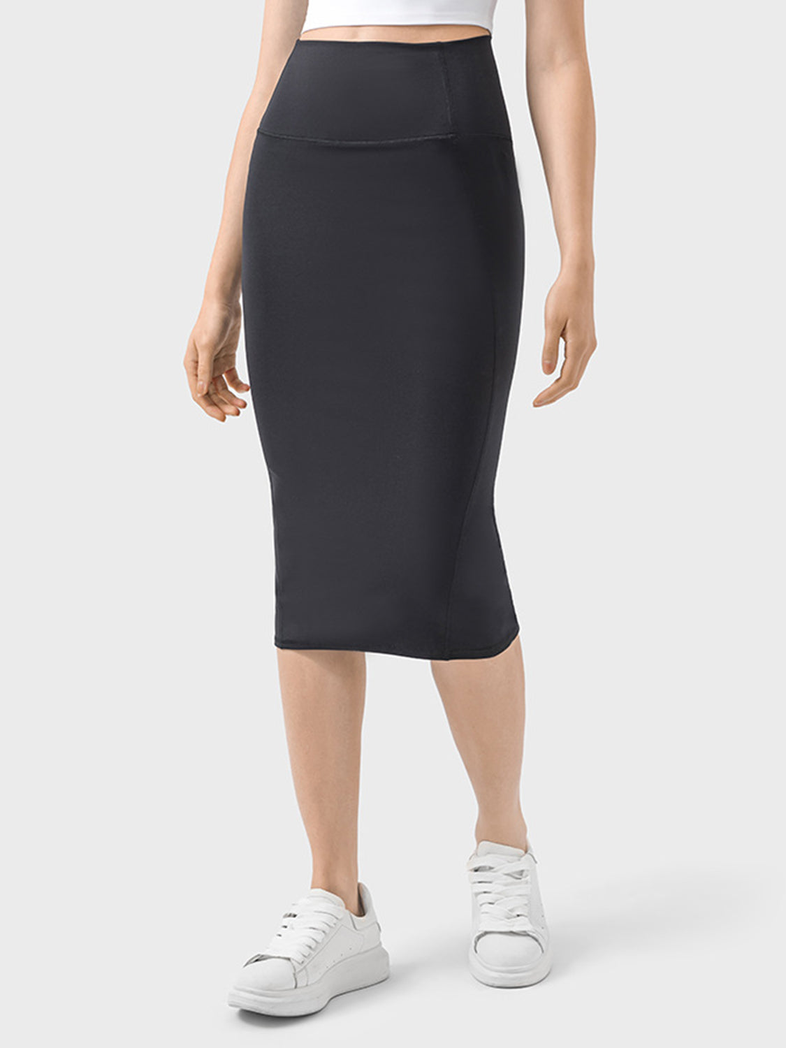 Model showcasing a sleek black Millennia Slit Wrap Active Skirt, perfect for active and casual wear with stretchy comfort.