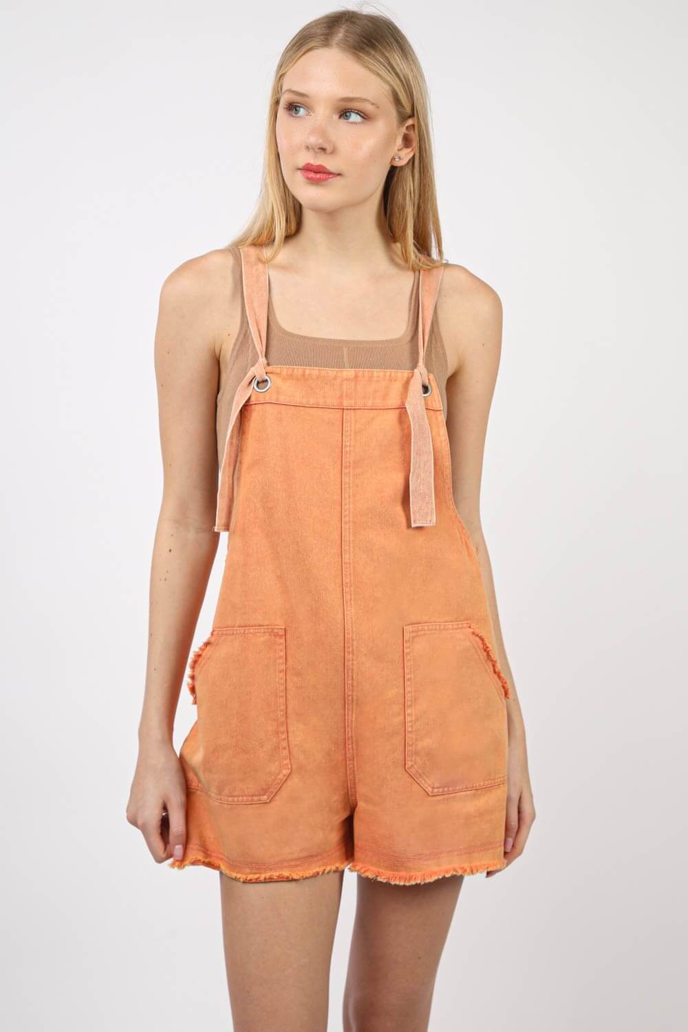 Trendy vintage-style washed frayed hem denim romper overall with side and back pockets, perfect for a casual and eco-friendly outing.