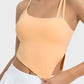 Millennia Slit Asymmetrical Neck Active Cami in peach with stylish slits and sleek straps for workouts.