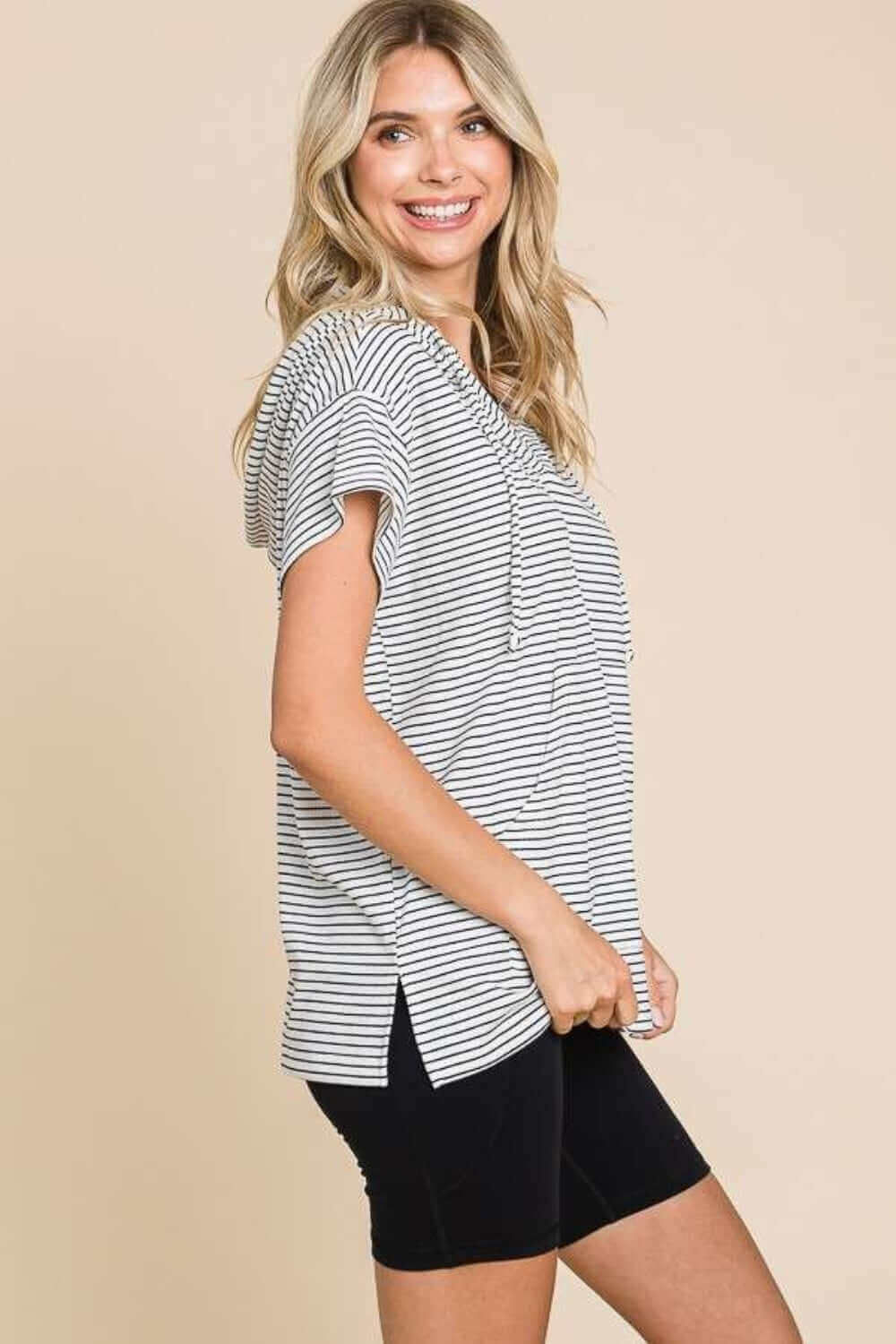 Woman wearing Striped Short Sleeve Hooded Top with black shorts, showing casual and trendy sporty style.