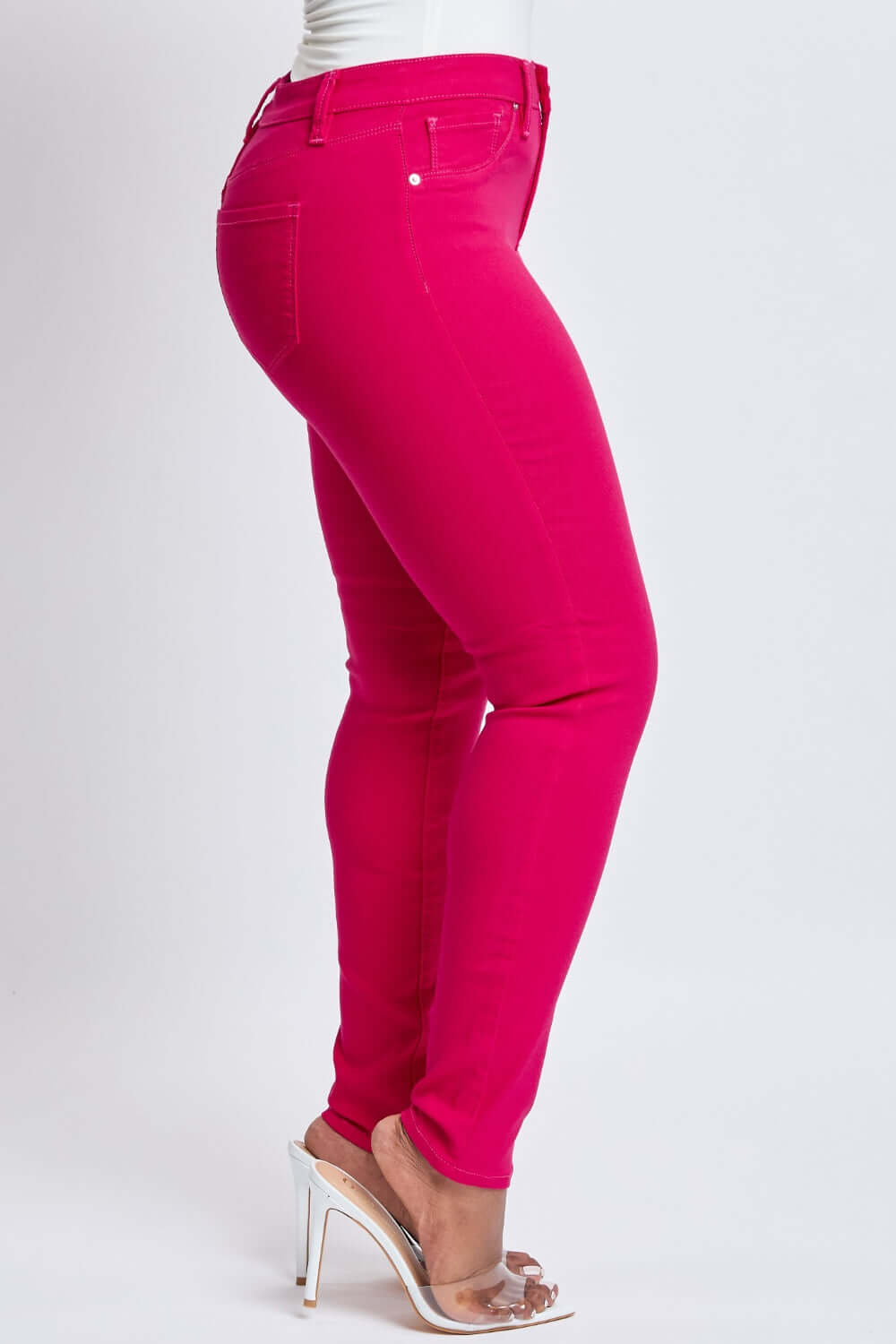 Bright pink Hyperstretch Mid-Rise Skinny Jeans by YMI Jeans, showcasing ultra-stretchy fabric, mid-rise waist, and sleek skinny leg design.