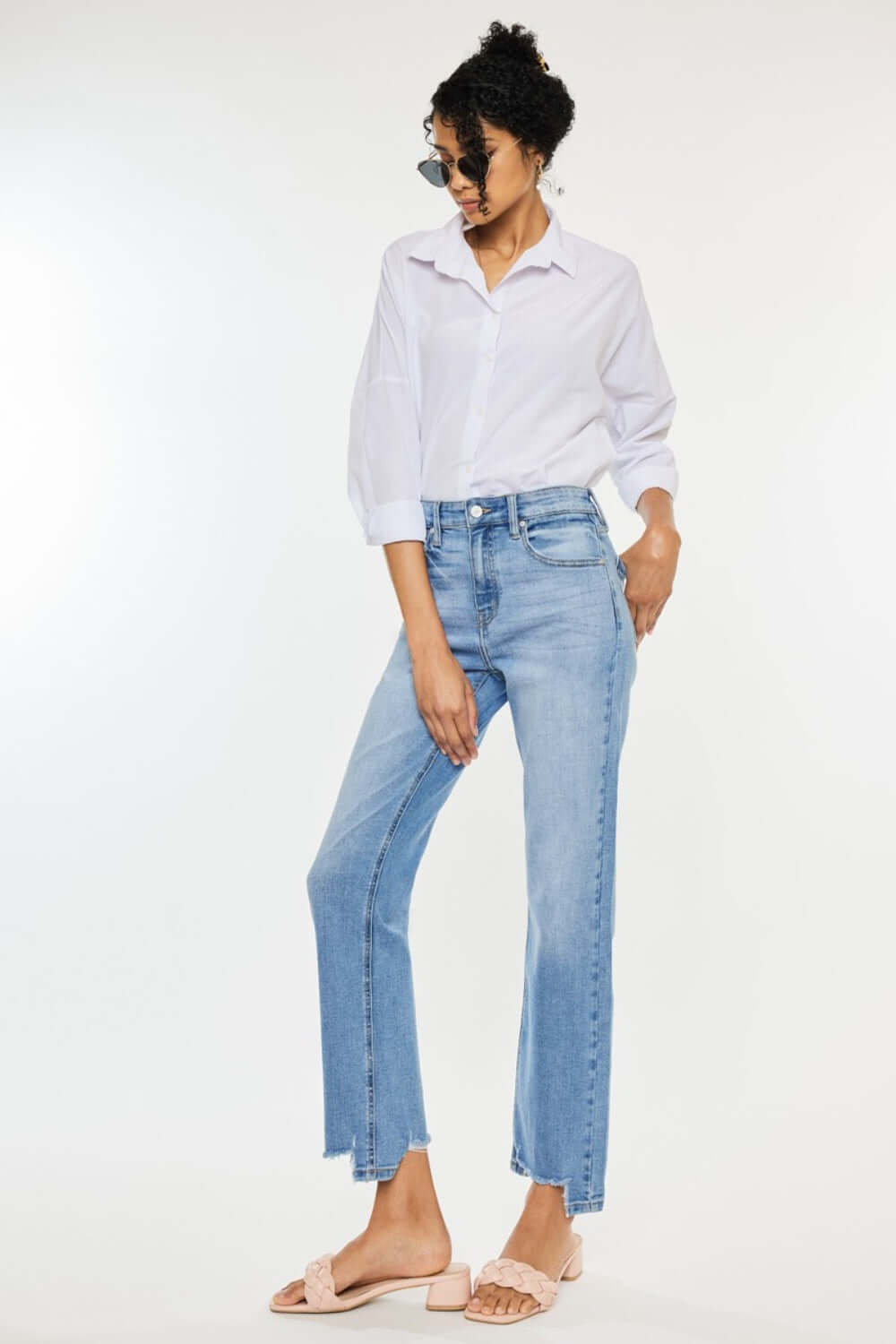 Model wearing high waist raw hem straight jeans paired with a white shirt and sandals for a chic casual look.