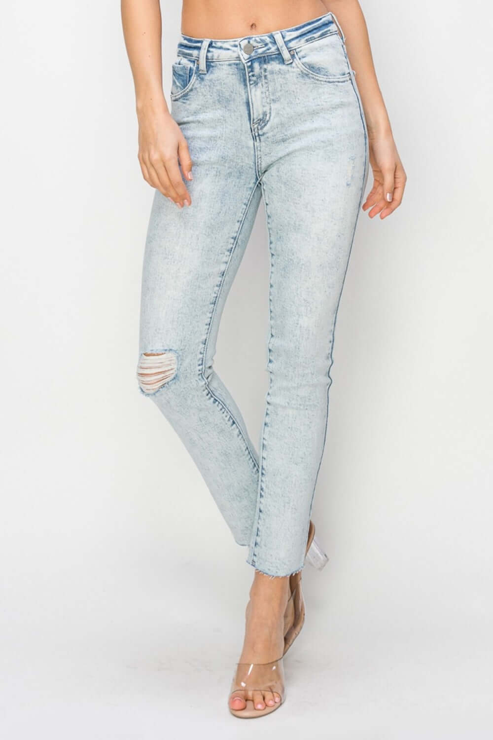 High rise distressed skinny jeans featuring a ripped knee, perfect for casual outfits - Risen Jeans.