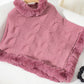 Soft dusty pink Bella Road Fuzzy Hem Cable-Knit Poncho draped over a chair, showcasing its cozy style and texture.