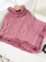 Soft dusty pink Bella Road Fuzzy Hem Cable-Knit Poncho draped over a chair, showcasing its cozy style and texture.