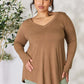 Woman wearing a long sleeve V-neck top in brown, showcasing its luxurious rayon fabric and flattering neckline.