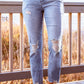 Stylish distressed cropped jeans with slight stretch in a solid pattern, featuring a casual look, photographed in a studio setting.