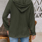 Woman wearing a drawstring dropped shoulder long sleeve hoodie in green, viewed from the back with a casual outdoor setting.