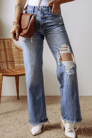 Distressed straight leg jeans with pockets, featuring raw hems. Perfect casual look with a stylish brown shoulder bag and white boots.