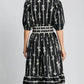 Back view of Umgee bow tie print midi dress featuring a notched neckline and velvet trim, perfect for elegant occasions.