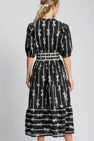 Back view of Umgee bow tie print midi dress featuring a notched neckline and velvet trim, perfect for elegant occasions.