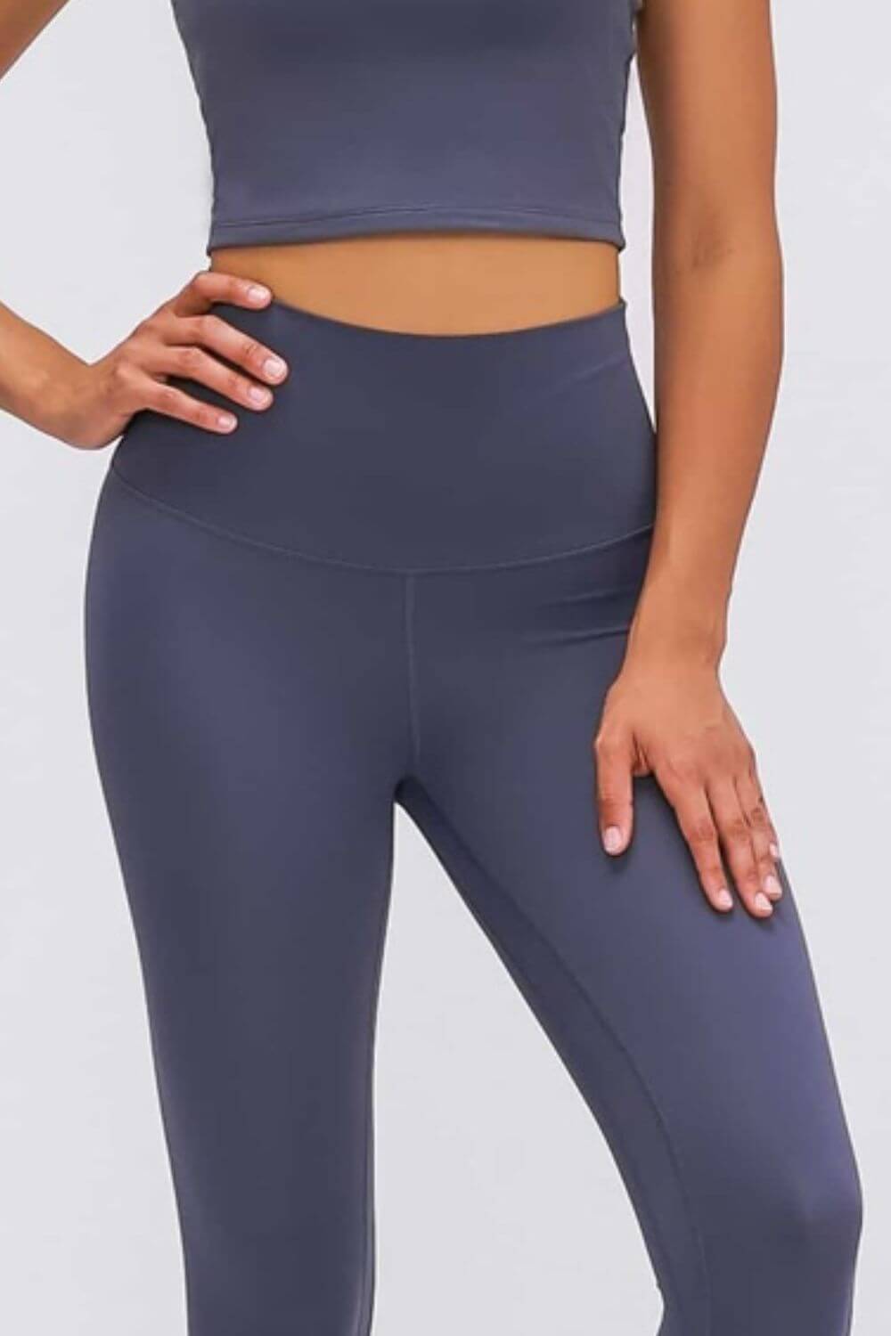 Ultra soft high waist leggings in solid navy blue, paired with a cropped top for a chic athleisure look.