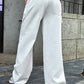 Woman wearing Bella Road wide leg jeans with pockets in white, low waist, buttoned and slightly stretchy material, back view