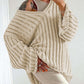 Woman wearing Bella Road V-Neck Long Sleeve Sweater in cream, showcasing trendy fall fashion with versatile, cozy design.