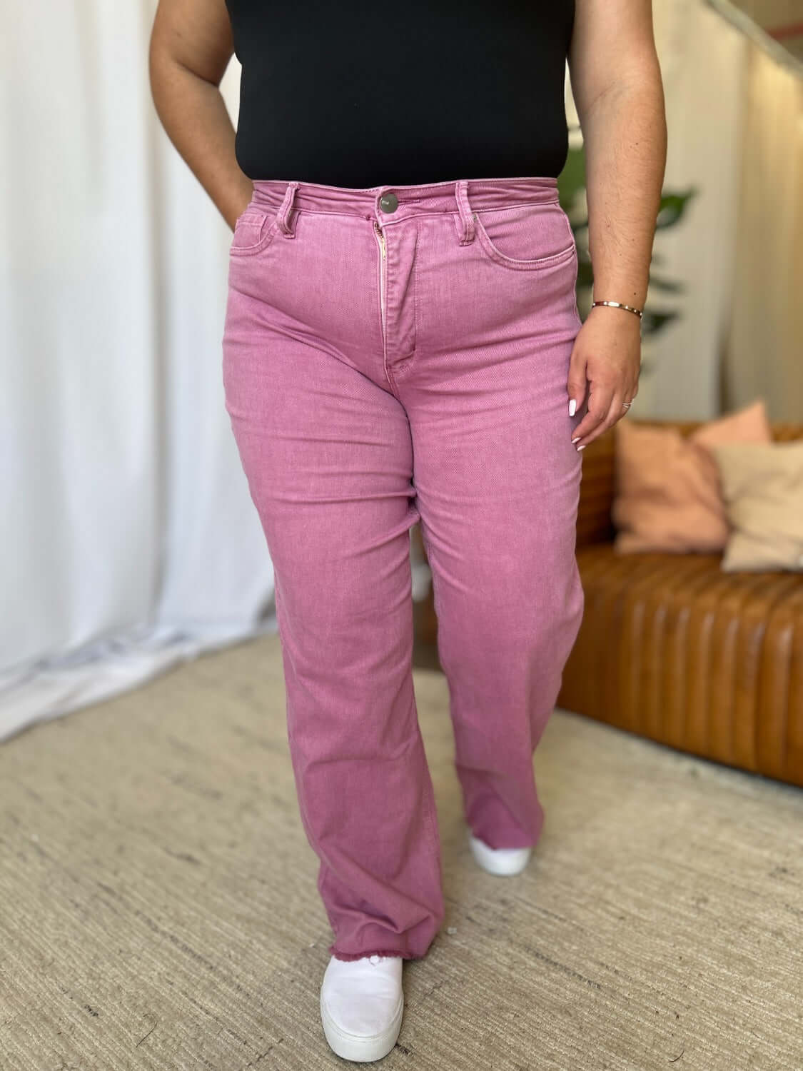 Woman wearing RFM Full Size High Rise Garment Dye Wide Leg Jeans in rich pink color, stylish high-waist fit, soft and comfortable fabric.